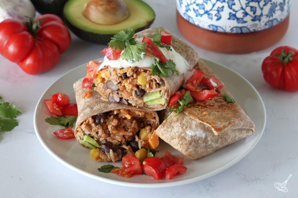 Ground Turkey Burritos stacked on a plate.