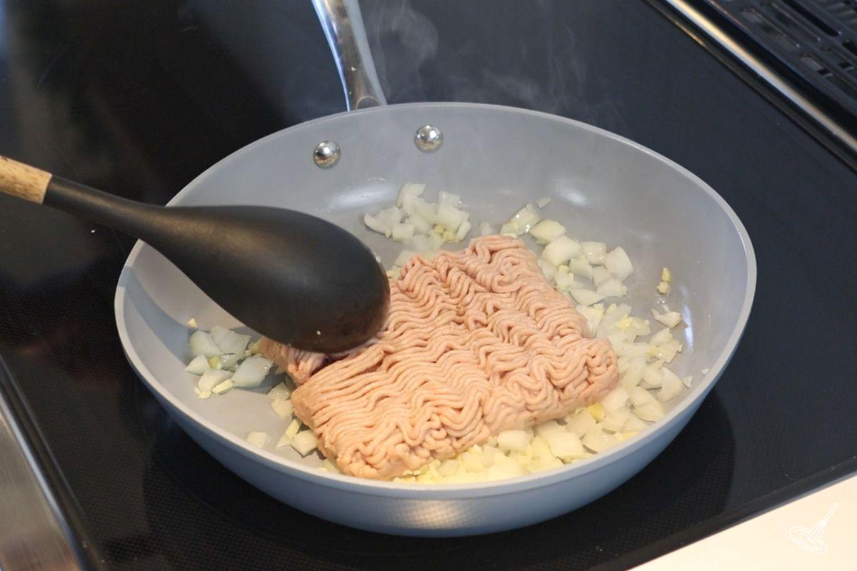 Ground turkey cooking in a frying pan.