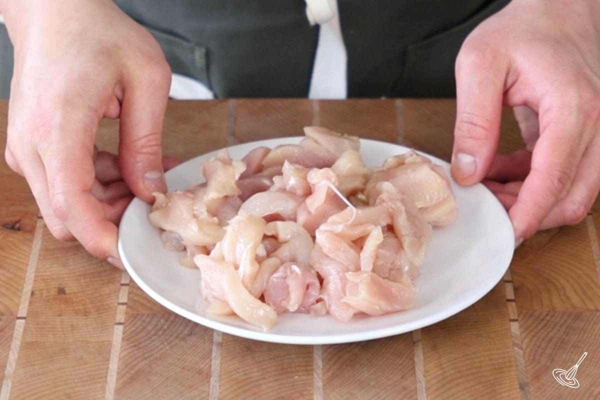 A plate of thinly sliced chicken breast.