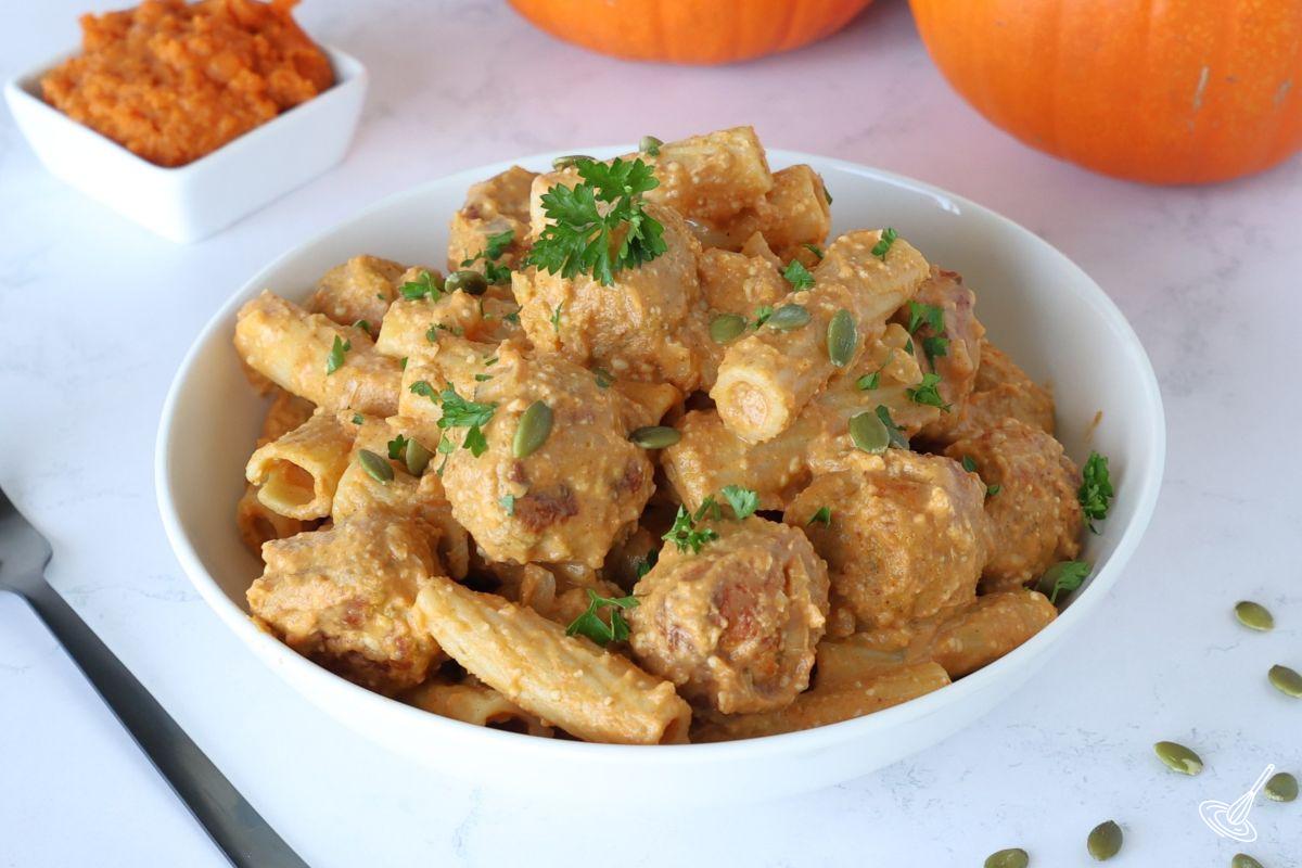 A bowl of pumpkin turkey meatballs with pasta. 