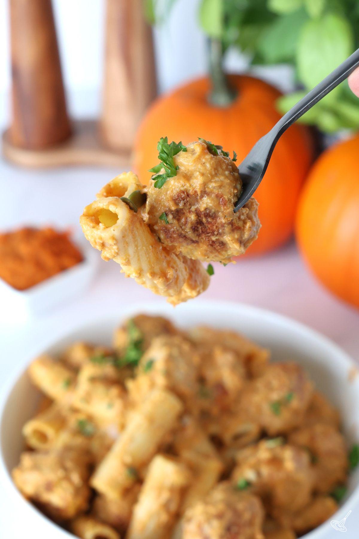 A fork holding a pumpkin turkey meatball. 