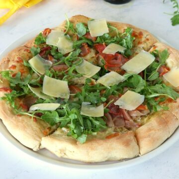 Prosciutto Arugula Pizza on a plate.
