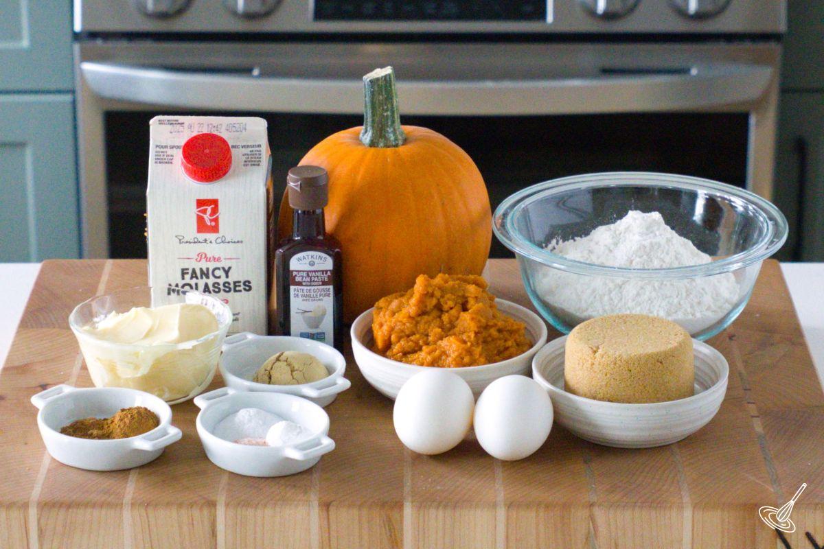 Ingredients on a wood board to make a pumpkin gingerbread cake.