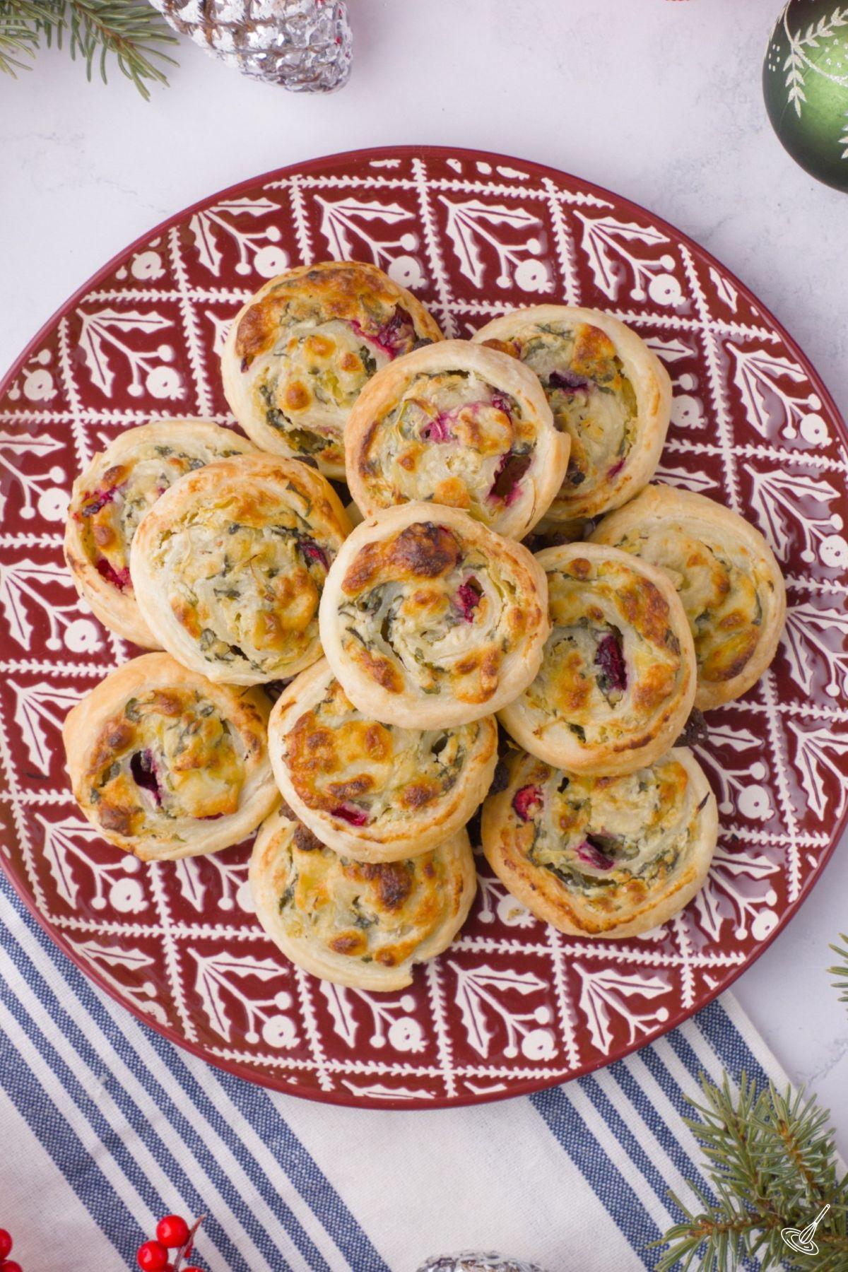 A plate of baked Spinach and Artichoke Pinwheels. 