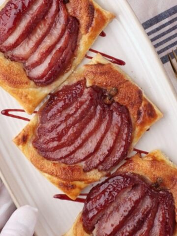 poached pear pastry tarts on a plate
