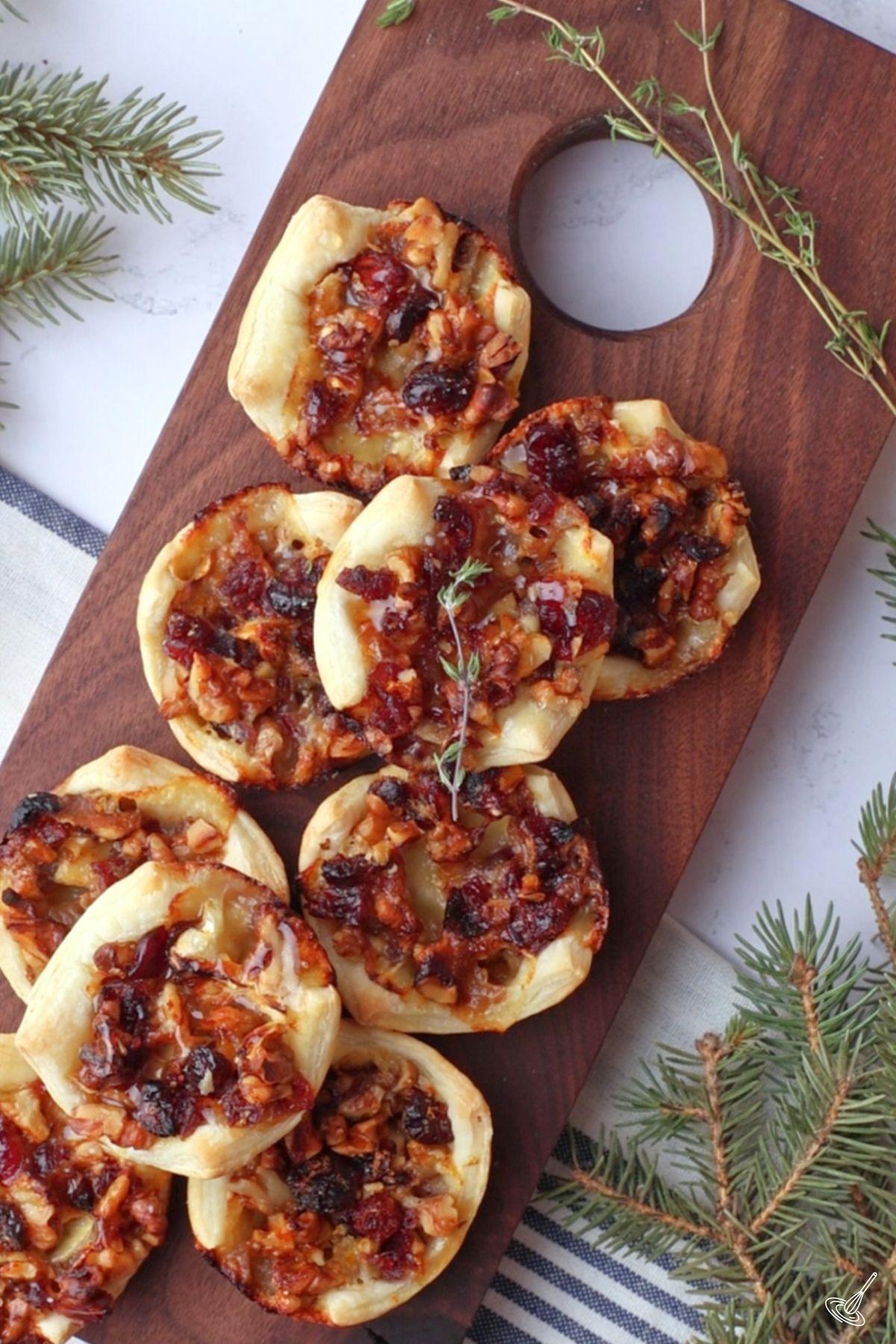 Brie and Walnut Honey Tarts on a serving board. 