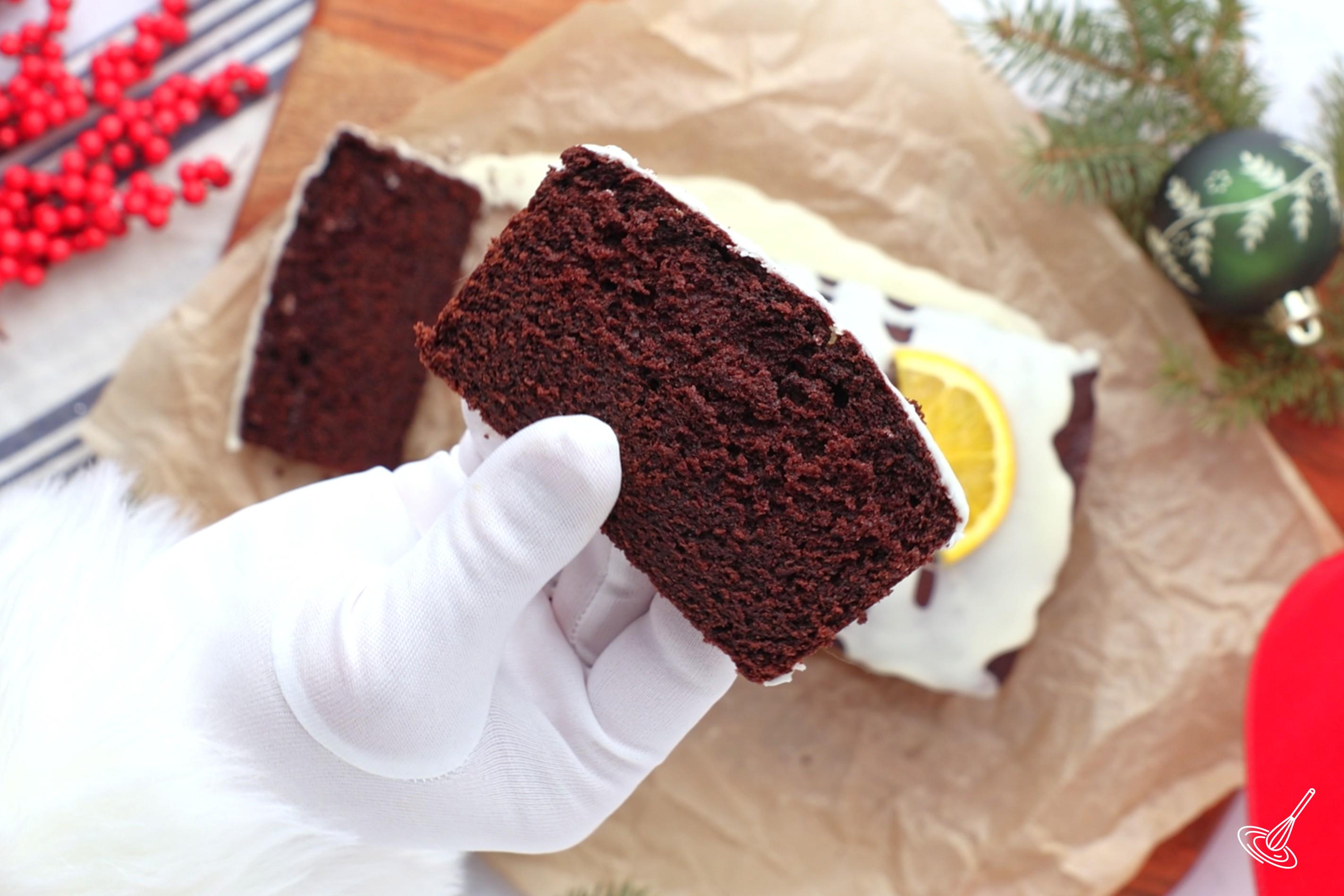 Someone holding a slice of chocolate orange loaf.