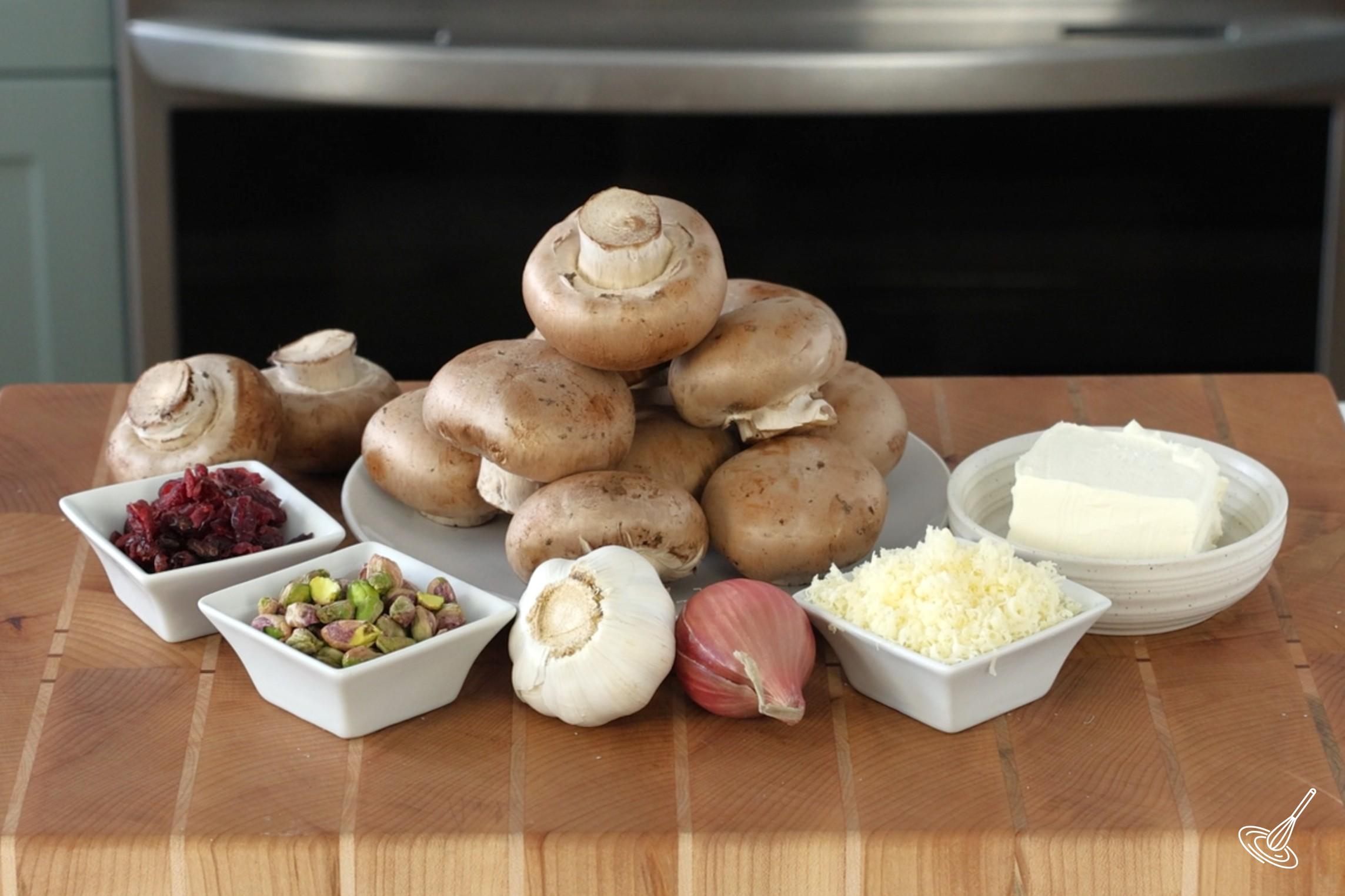 Ingredients to make stuffed mushrooms, including cranberries and pistachios.