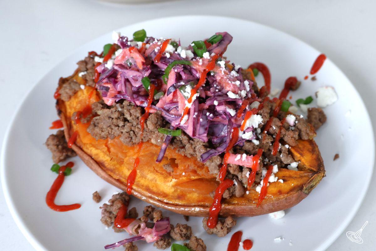 A garnished ground beef sweet potato on a plate. 
