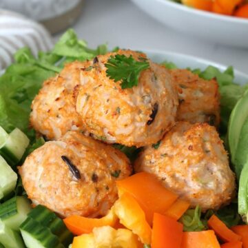 Chicken and Rice Meatballs on top of a salad.