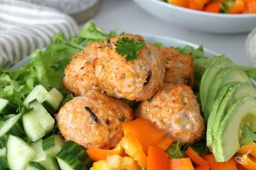 Chicken and Rice Meatballs on top of a salad.