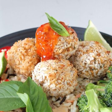 Baked Coconut Shrimp Meatballs on a bed of rice with vegetables.