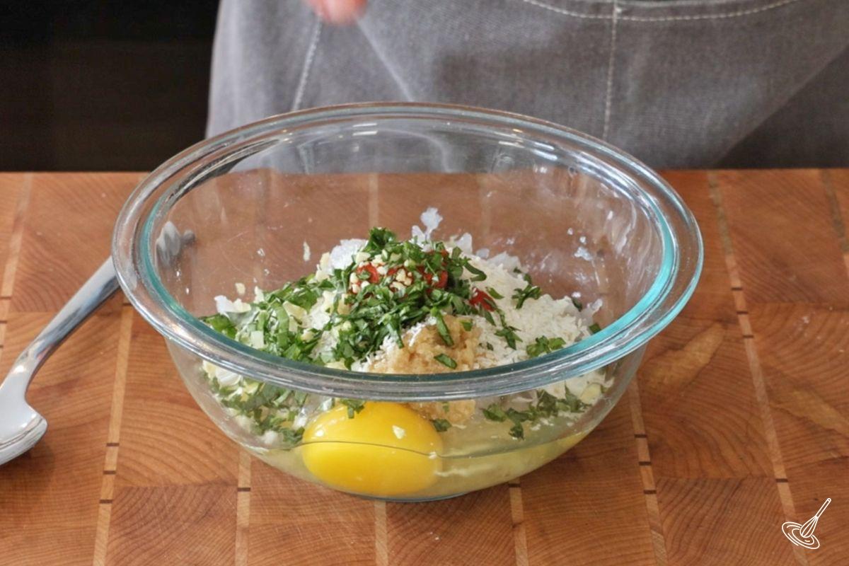 A bowl of ingredients to make shrimp meatballs.