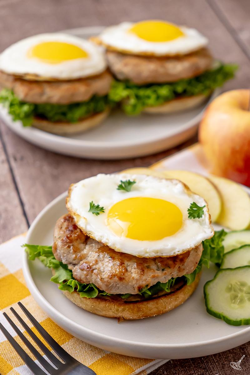 Turkey breakfast patties served on english muffins with egg on top.