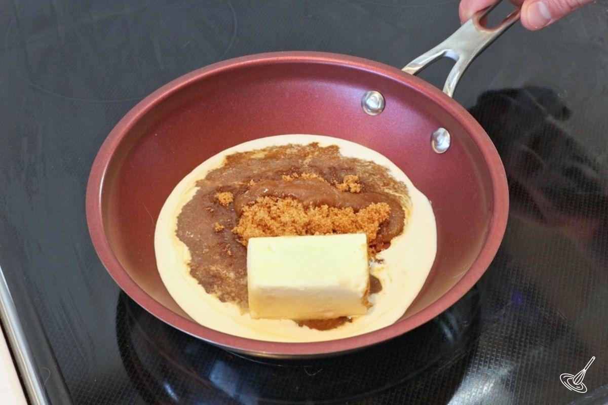 A frying pan containing butter, brown sugar and cream.