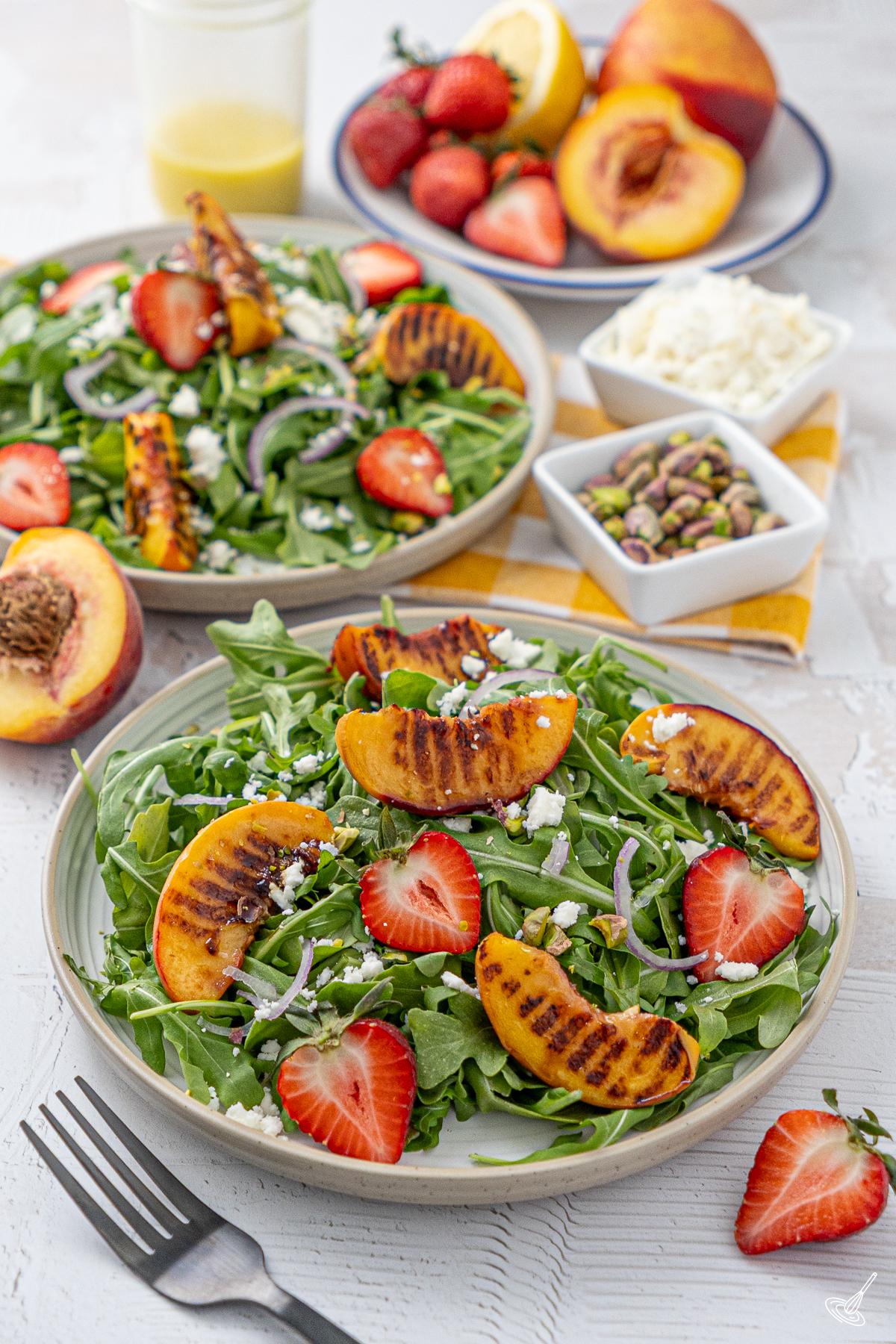A plate of Grilled peach and arugula salad.