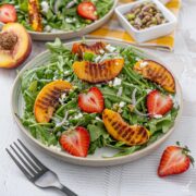 Grilled Peach and Arugula Salad on a plate.