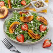 Grilled Peach and Arugula Salad on a plate.