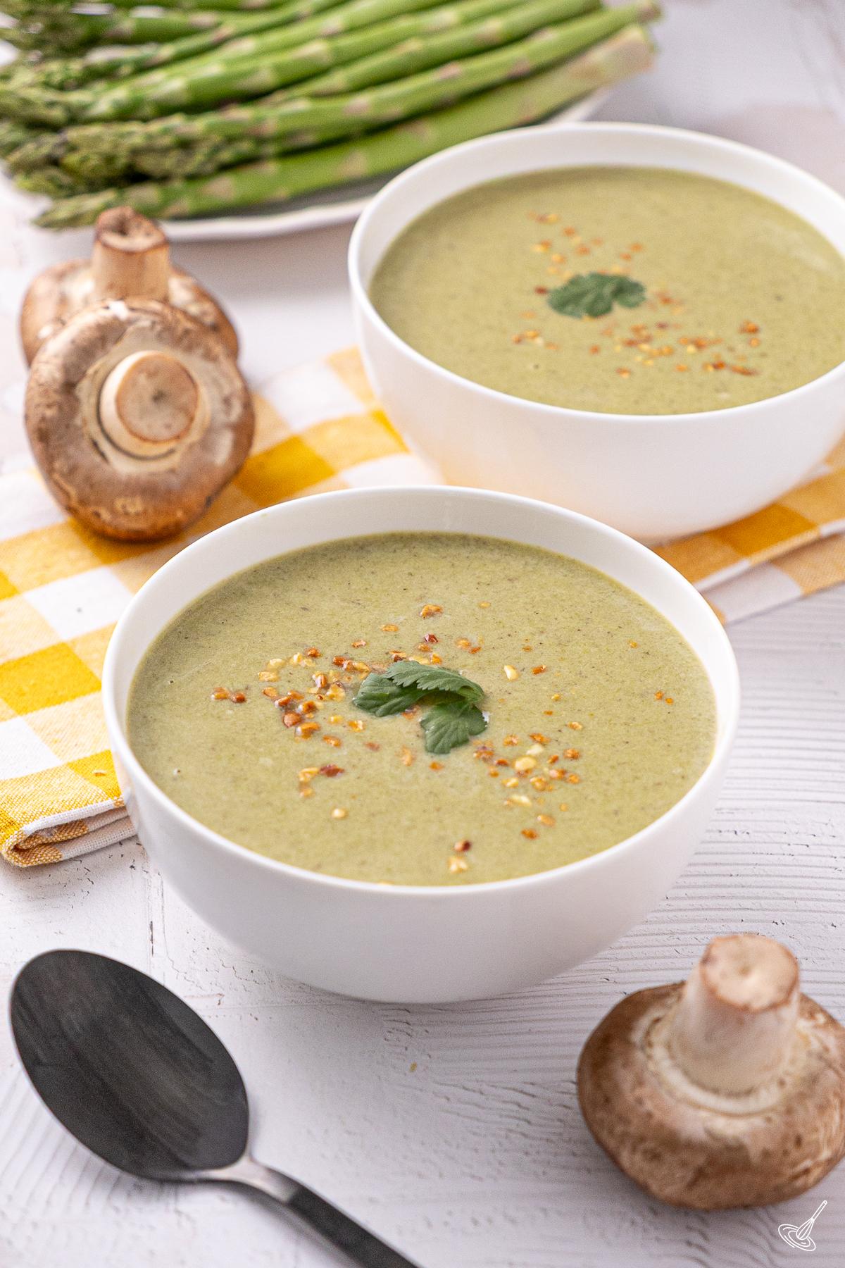 Bowls of Coconut Asparagus Soup on the table. 