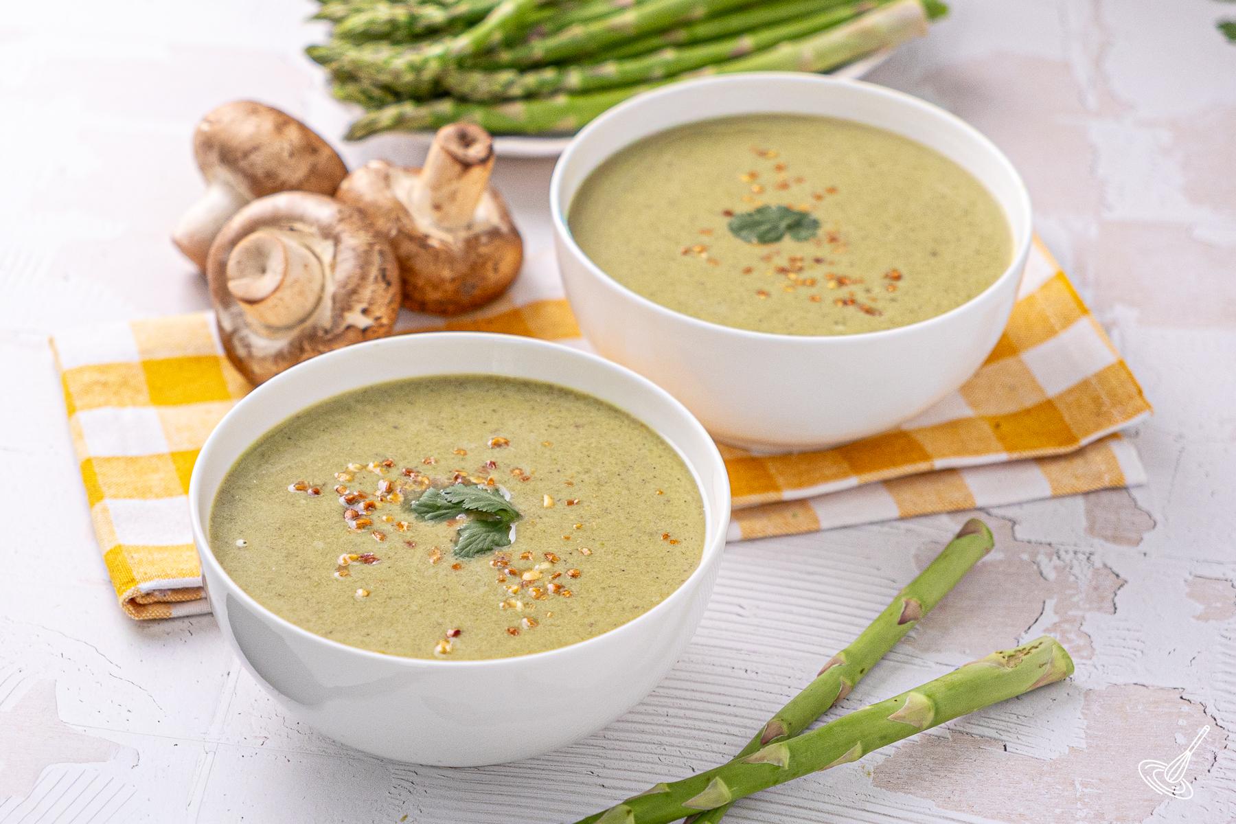 Bowls of Coconut Asparagus Soup on a table.
