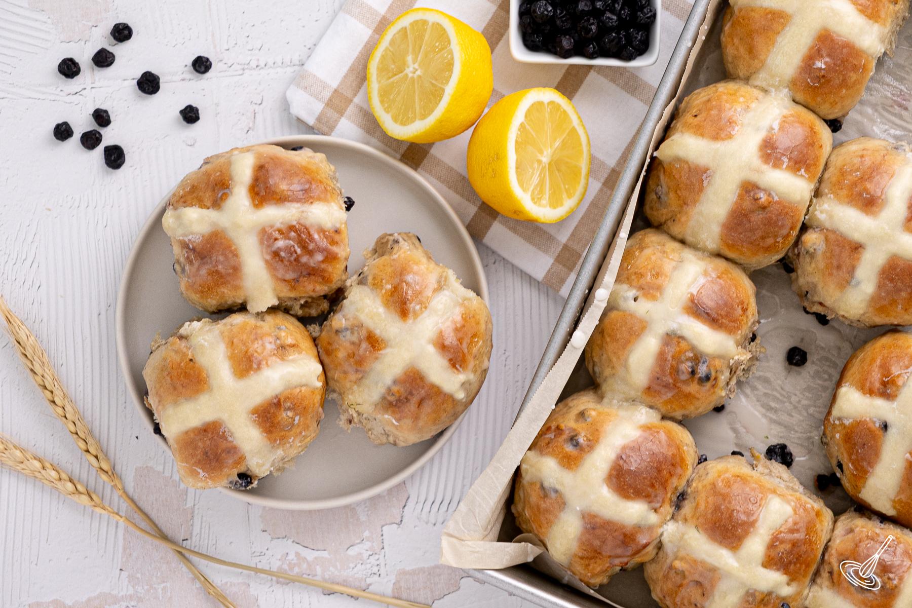 Blueberry Lemon Hot Cross Buns on a plate. 
