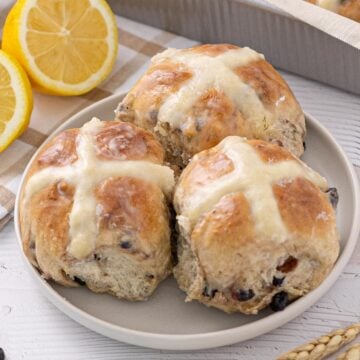 Blueberry Lemon Hot Cross Buns on a plate.