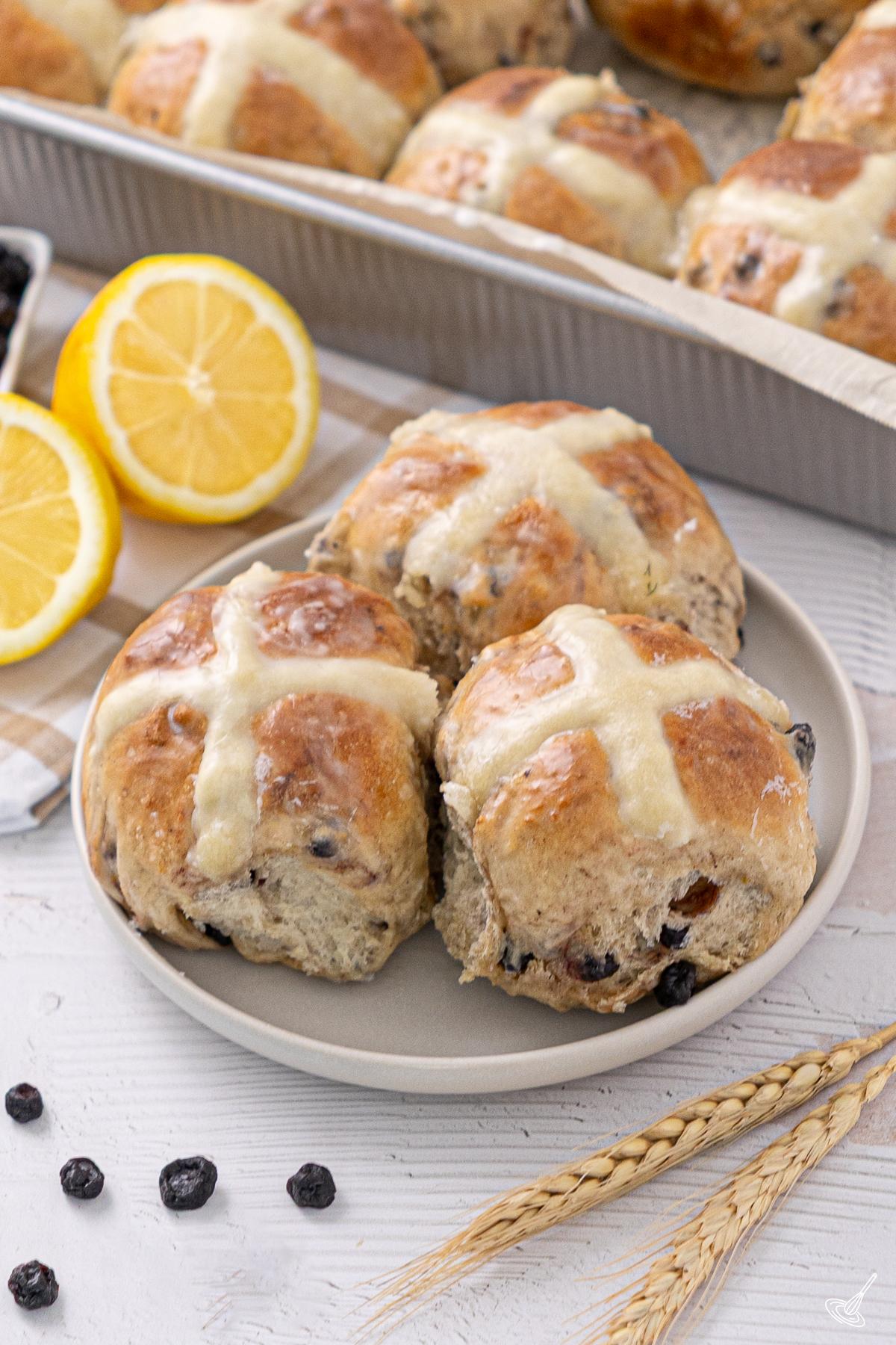 Blueberry Lemon Hot Cross Buns on a plate.