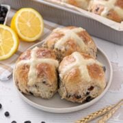 Blueberry Lemon Hot Cross Buns on a plate.