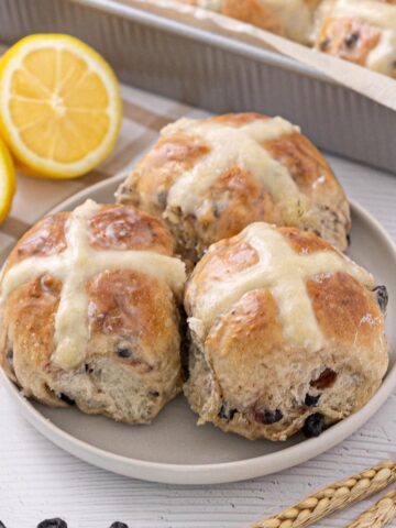 Blueberry Lemon Hot Cross Buns on a plate.