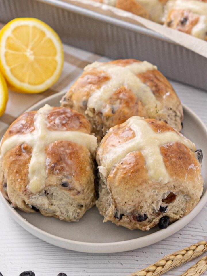 Blueberry Lemon Hot Cross Buns on a plate.