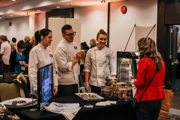 Alix with his staff at a cooking fundraising event.