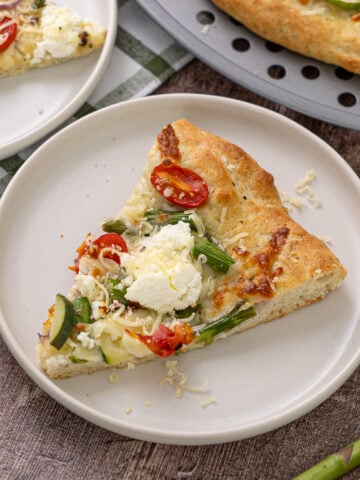 A slice of Primavera pizza on a plate.