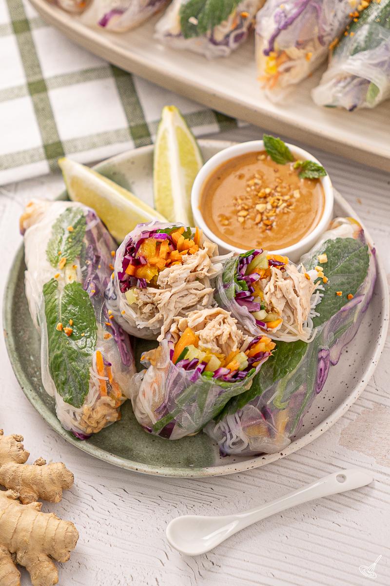 A plate of leftover turkey summer rolls with a side dish of spicy peanut sauce. 