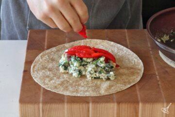 Place cooked egg white and spinach filling in flour tortilla and wrap.