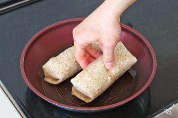 Place rolled up spinach feta Egg white wraps in a pan to grill.