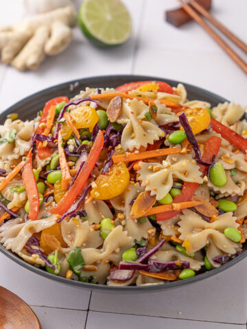 Asian Pasta salad with miso dressing in a serving bowl.