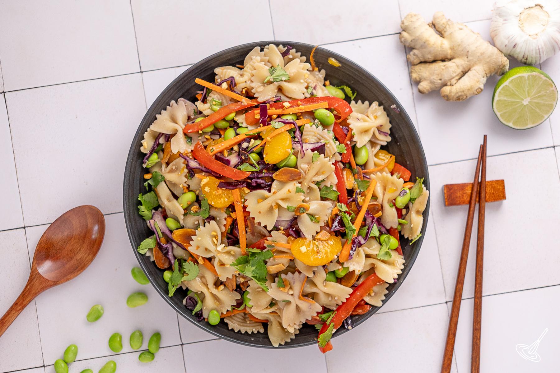 Asian pasta salad with miso dressing in a serving bowl.