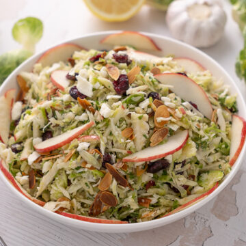 Shaved brussels sprout salad in a serving bowl.