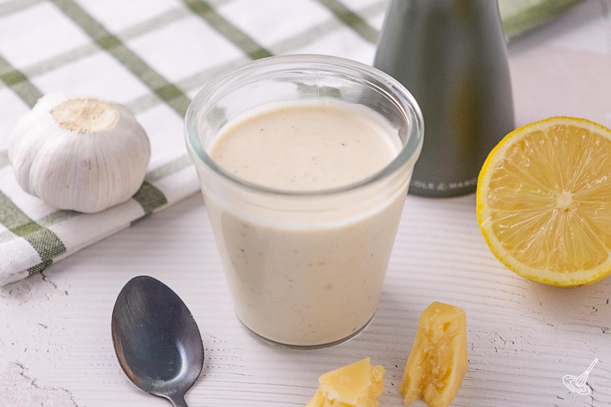 A jar of homemade Caesar salad dressing.
