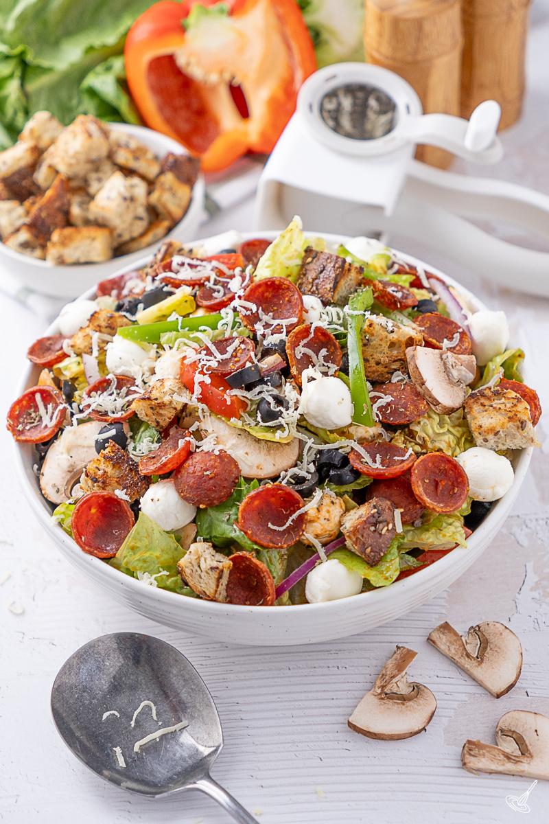 Deluxe Pizza Salad recipe in a serving bowl.