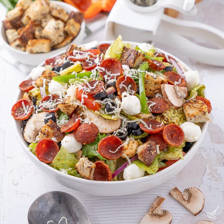 Deluxe Pizza Salad recipe in a serving bowl.
