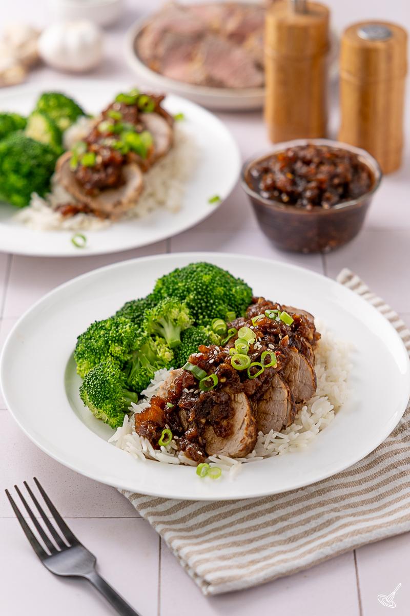 A portion of Pineapple Teriyaki Pork Tenderloin served over rice with broccoli.