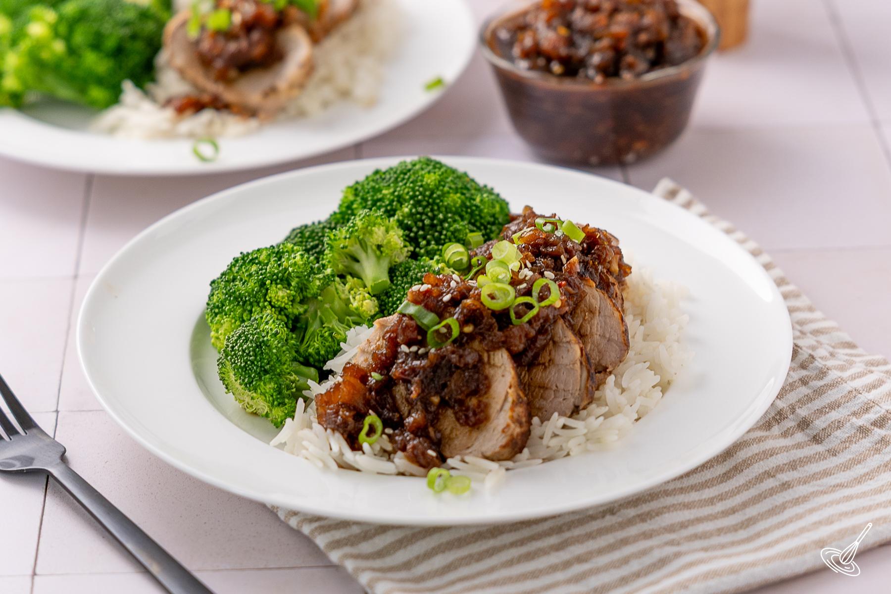 A portion of Pineapple Teriyaki Pork Tenderloin served over rice with broccoli. 