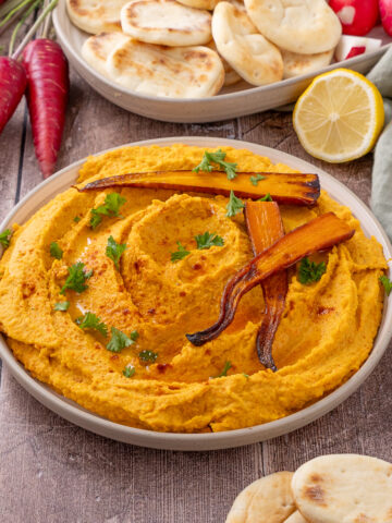 Roasted Carrot White Bean Hummus on a serving plate.