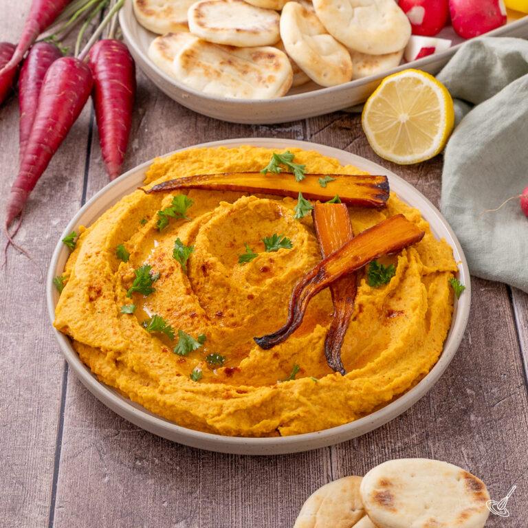 Roasted Carrot White Bean Hummus on a serving plate.