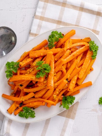 orange marmalade glazed carrots on a serving plate.