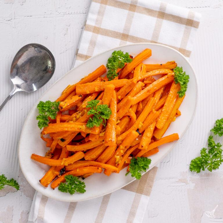 orange marmalade glazed carrots on a serving plate.